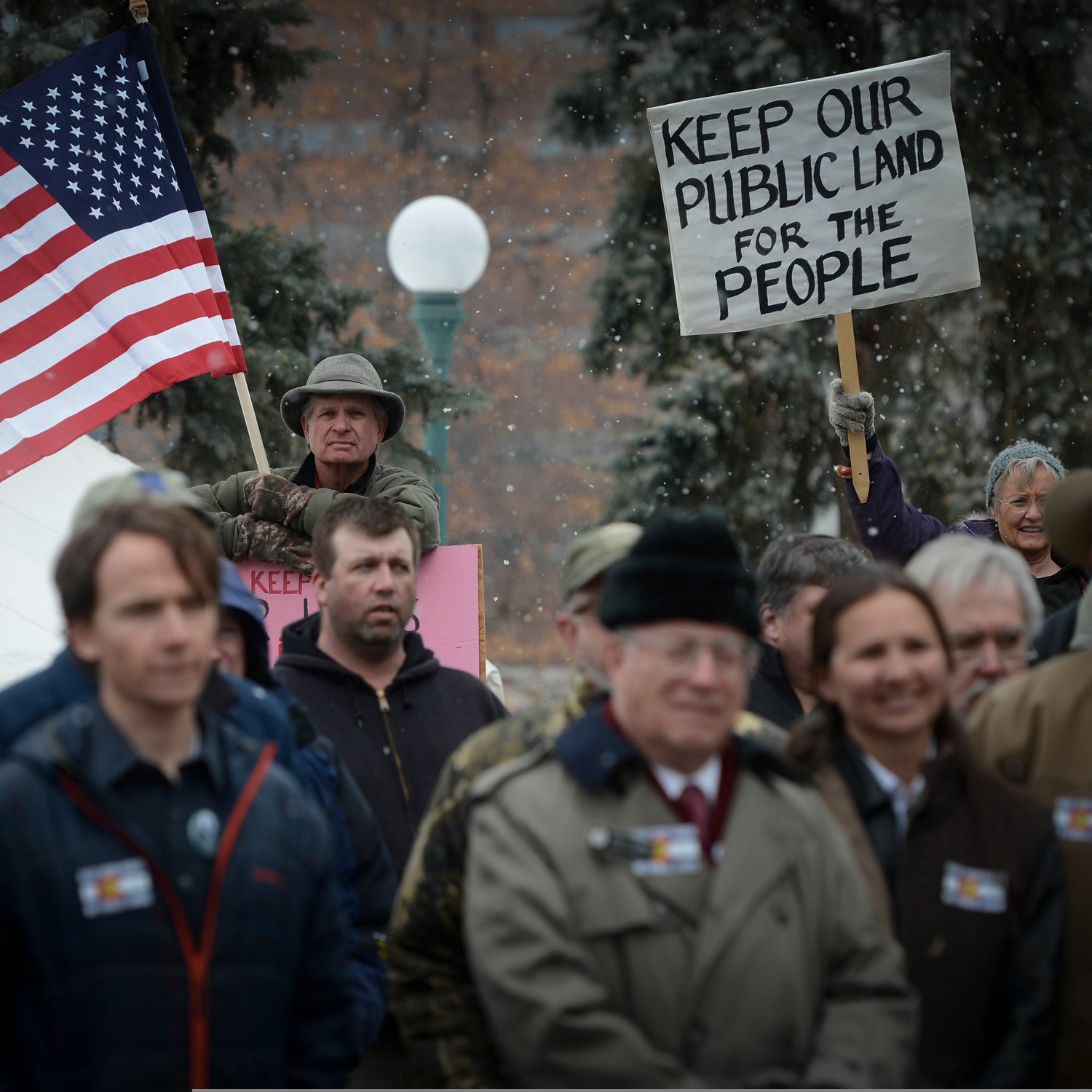 File Image: Outdoor enthusiasts Chris Madson (holding American flag) and Nancy Nixon (holding sign) show their support during a rally at the Denver, Colorado Capitol February 25, 2015 against the transfer and sale of public lands.