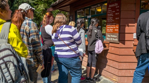 Tourists wait in line to pay entrance fees for Muir Woods National Monument, Mill Valley, California, September 5, 2016.