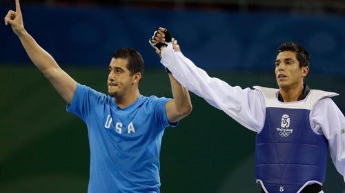 Steven Lopez (right) celebrates with his brother and coach Jean after a bronze medal match at the Beijing Olympics.