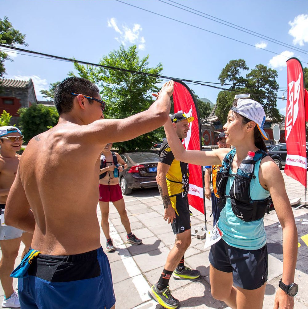 Runners high-five after one of China's growing number of races.