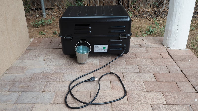 Smoke vents and a grease drip bucket are located on the back of the grill.