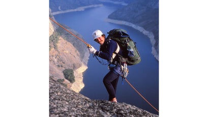 Rob Roy Ramey II rappels down into a peregrine nest above California's Hetch Hetchy reservior.