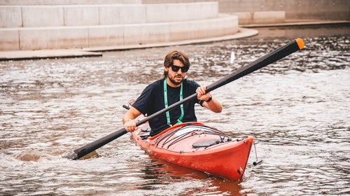 The author testing the Gearlab Aikak paddle at Outdoor Retailer Demo Day.