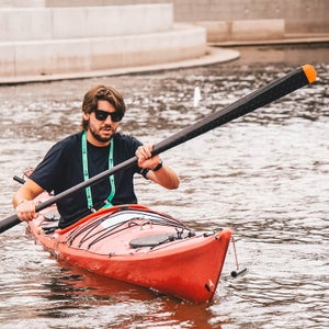 The author testing the Gearlab Aikak paddle at Outdoor Retailer Demo Day.