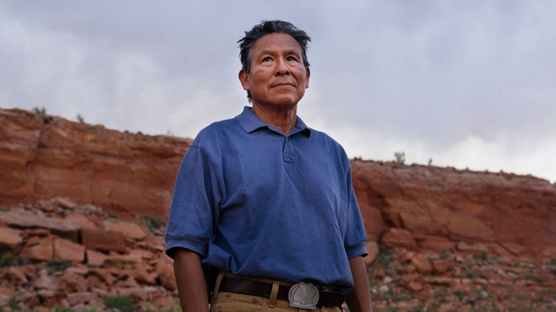 Mark Maryboy standing in red sand desert