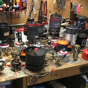 Our workbench covered in 29 stoves ready for testing.