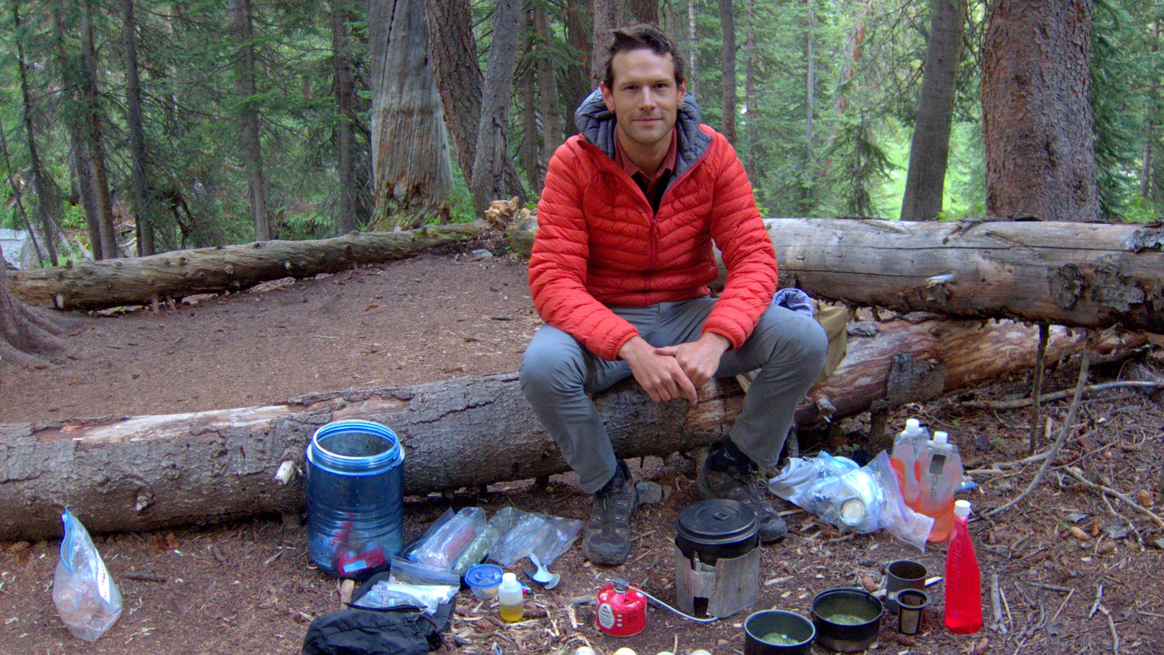The author preparing dinner, with his trusty bear canister nearby.