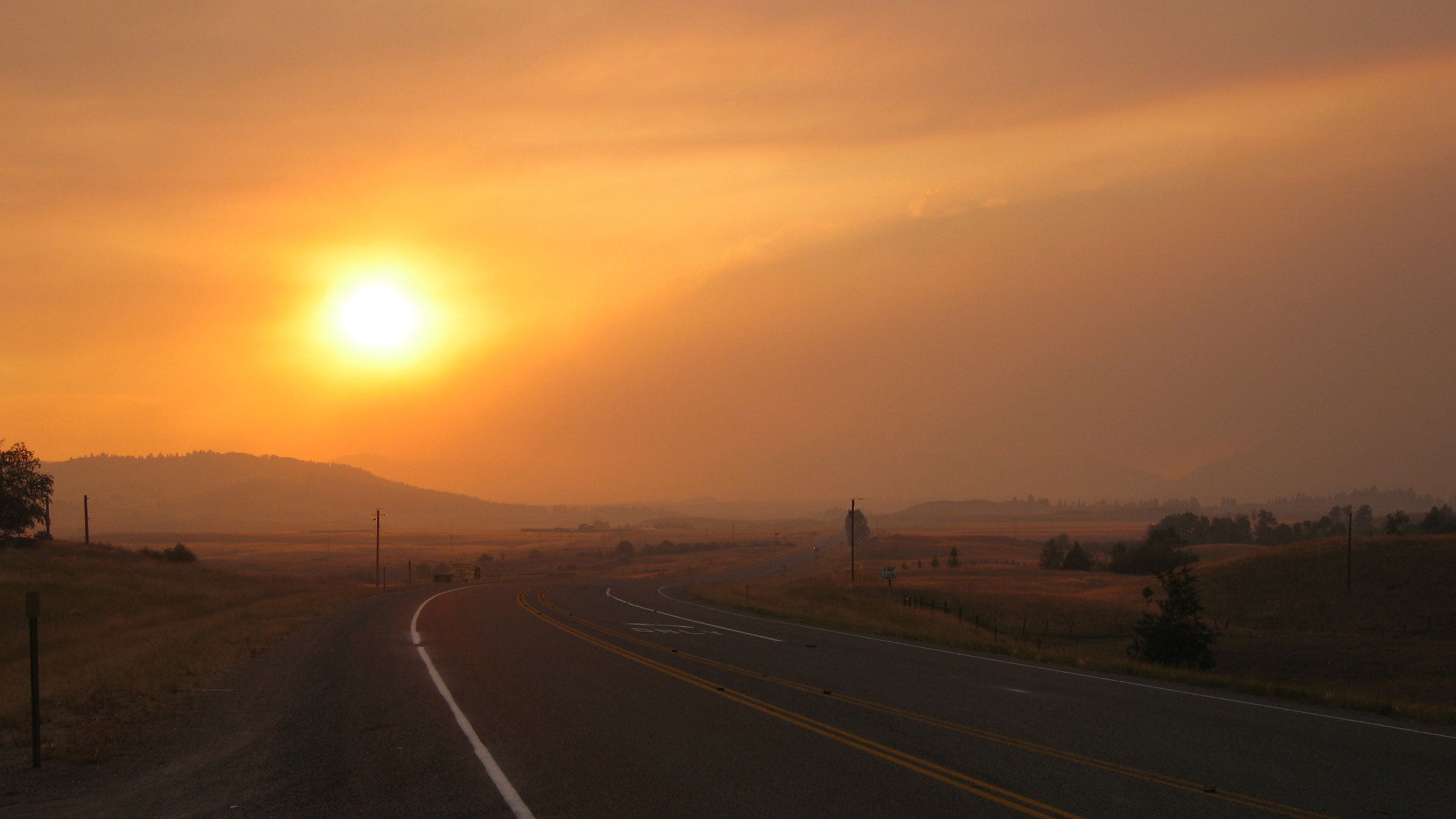 A dramatic sunset in Montana during a wildfire-caused road-walking detour.