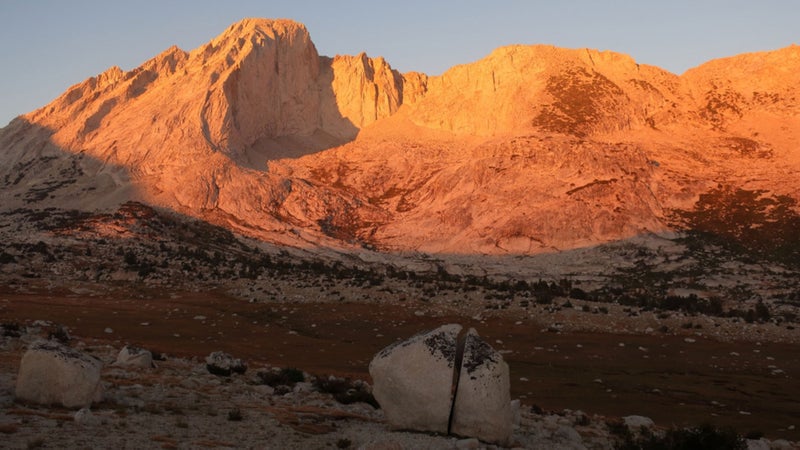 Alpenglow on Mt. Conness, a prominent peak on the Sierra Crest north of Tuolumne Meadows, with a perfectly split boulder.
