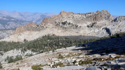 Obelisk Lake is perched in a hanging valley below Mt. Clark, two miles and 2,500 vertical feet away from the closest trail and guarded by sheer granite walls, extensive talus, and manzanita thickets.