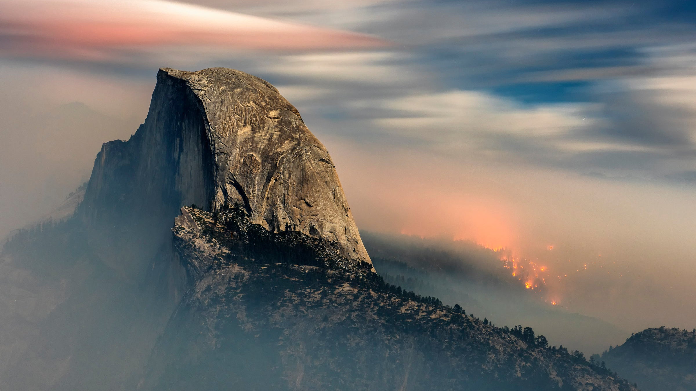 The Meadow Fire burns behind Half Dome. 