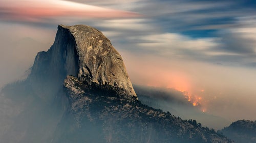The Meadow Fire burns behind Half Dome.