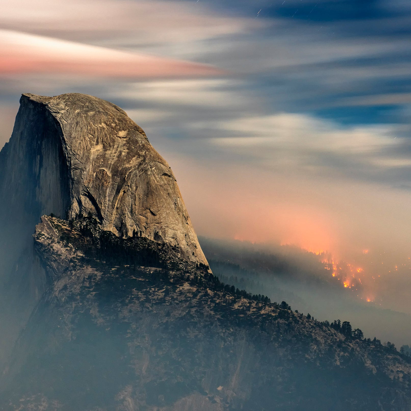 The Meadow Fire burns behind Half Dome in Yosemite National Park shortly before dawn in September, 2014.