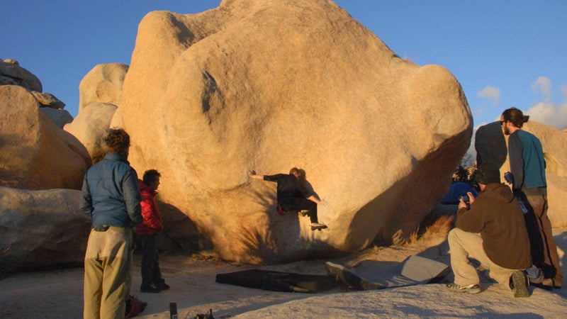 A climber bouldering in Joshua Tree.