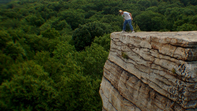 A hiker looks over a cliff in the Shawangunks.
