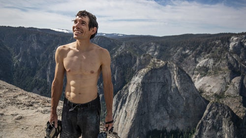 Alex Honnold holds all of his climbing gear atop the summit of El Capitan.