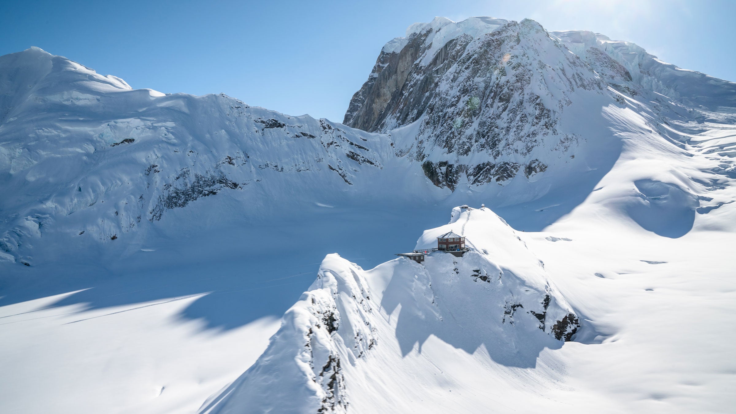 Guests arrive at the Sheldon Chalet by helicopter from Talkeetna and are welcomed with champagne, oysters, king crab legs, and knockout views of Denali’s 20,310-foot summit.