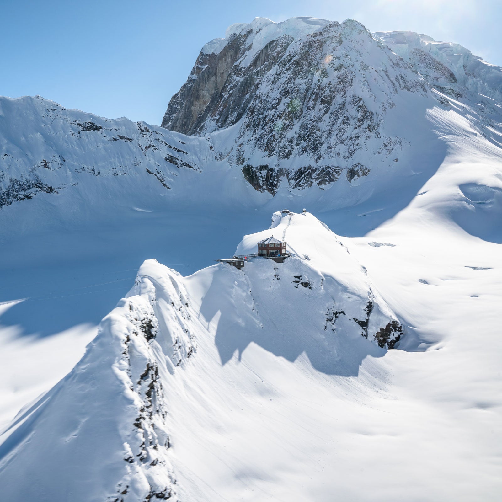 Guests arrive at the Sheldon Chalet by helicopter from Talkeetna and are welcomed with champagne, oysters, king crab legs, and knockout views of Denali’s 20,310-foot summit.