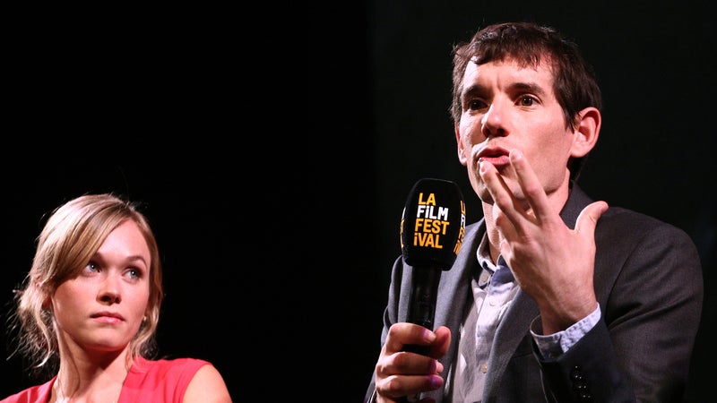 Sanni McCandless watches Alex Honnold, or perhaps his hands, as they speak onstage at a “Free Solo” screening.