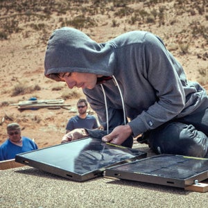 Alex Honnold works with a solar panel during an initiative for the Honnold Foundation.