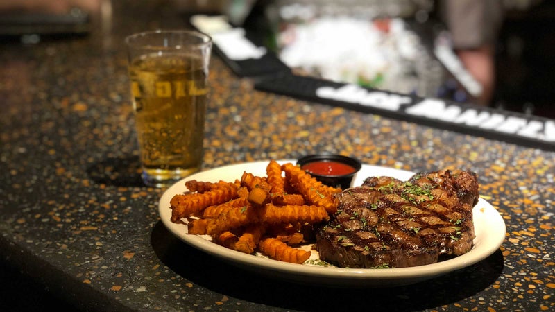 Rib-eye with sweet potato fries at Char Steak Lounge.