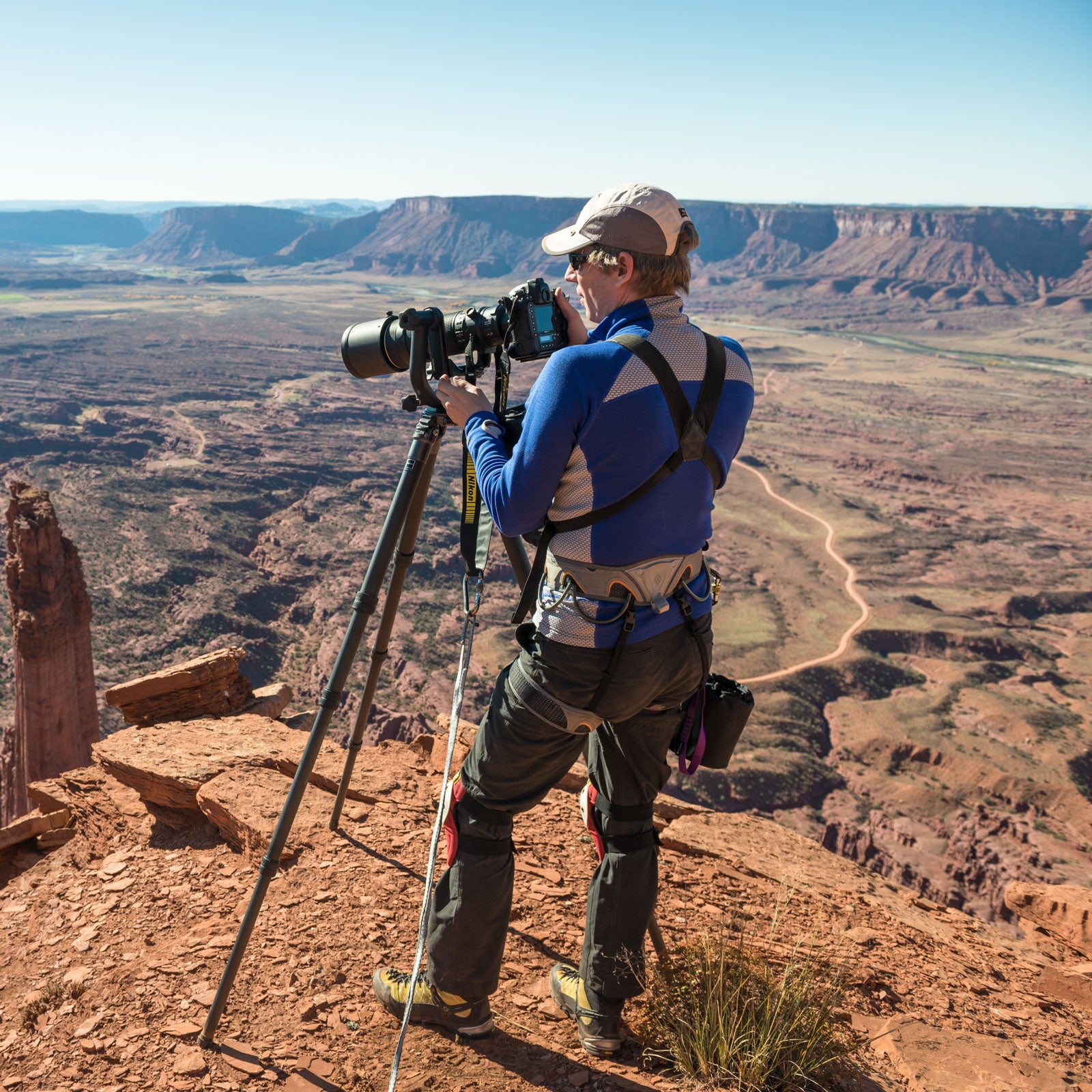 Michael Clark photographing Red Bull Air Force team members B.A.S.E. Jumping off the Fisher Towers near Moab, Utah.