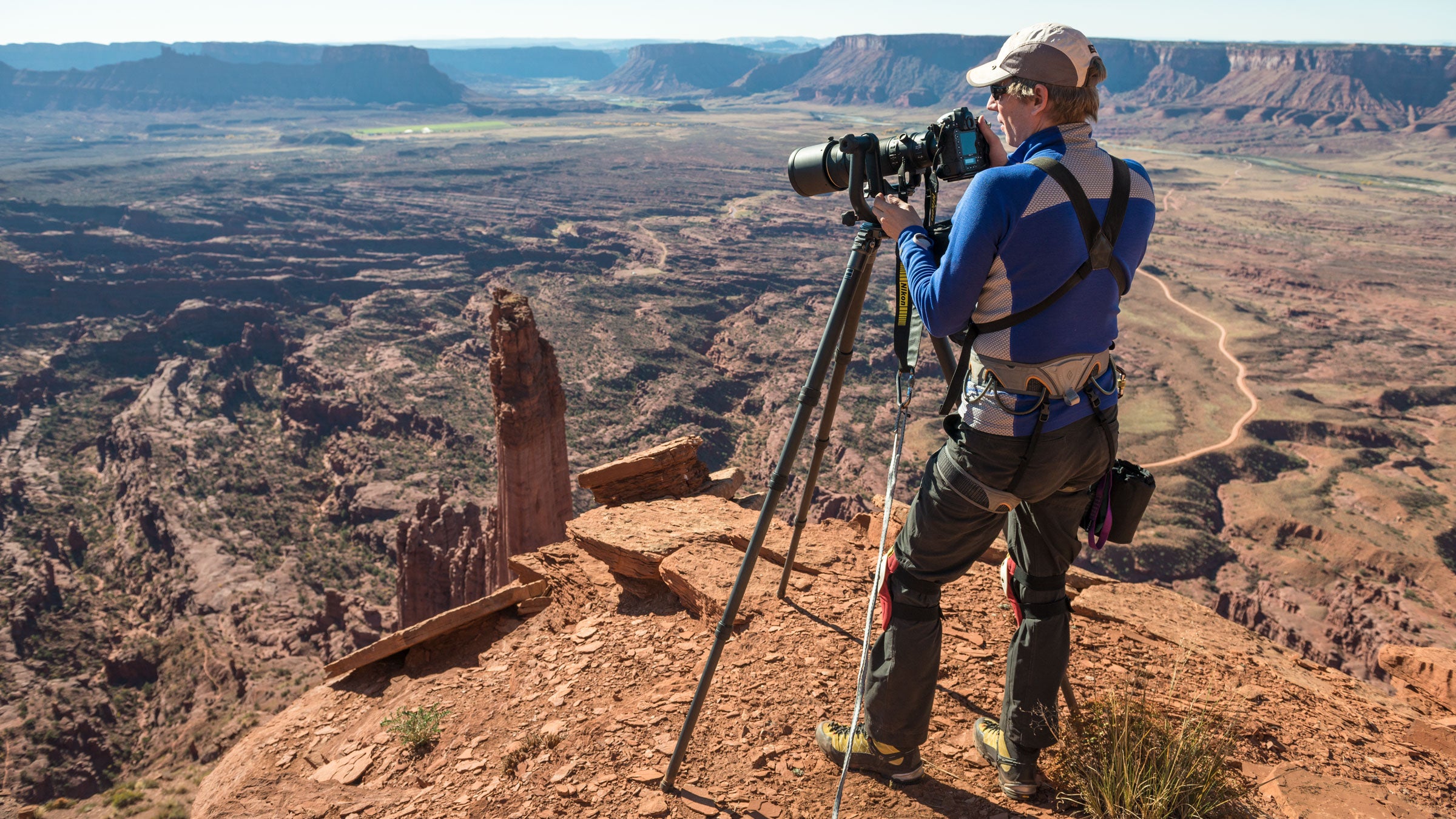 Michael Clark photographing Red Bull Air Force team members B.A.S.E. Jumping off the Fisher Towers near Moab, Utah.