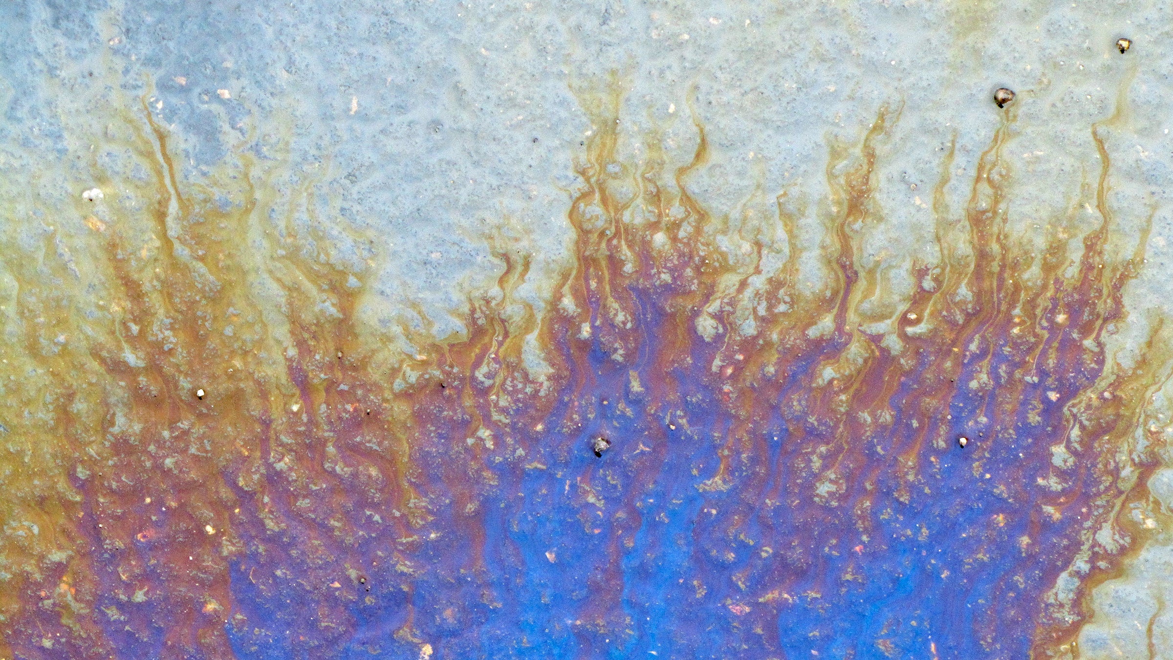 An oil spill on water. 