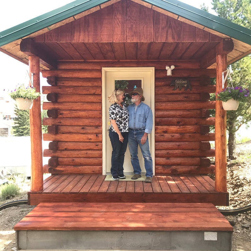 Carmela and Bill Moore on the porch of a cabin at Wild Bill's Bed and Breakfast.