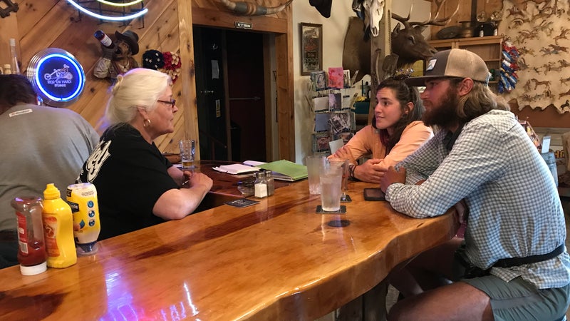 Laurel Nelson, co-owner of Miner's Grubstake and Dredge Saloon, with two thru-hikers.