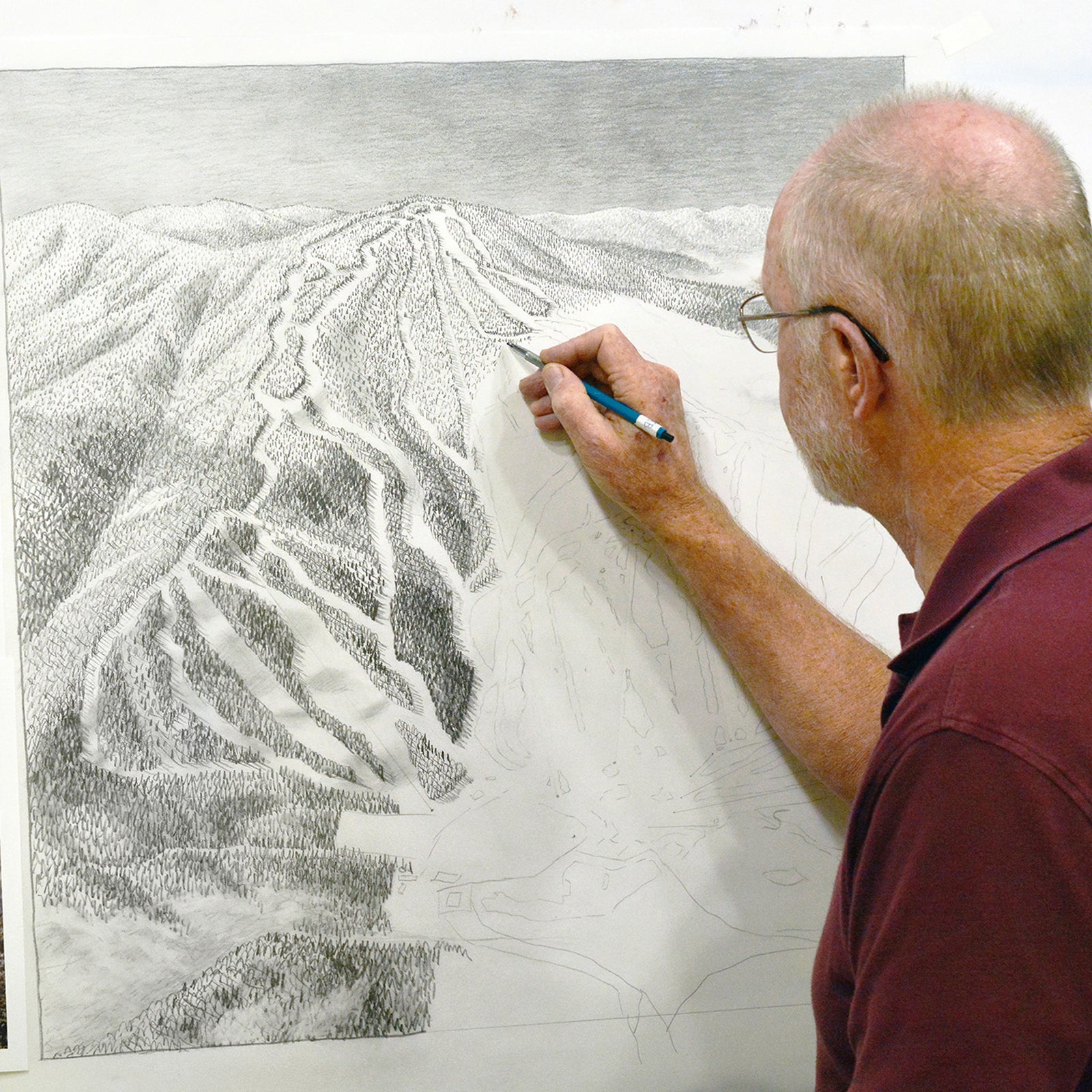 Neihus painting the trail map for Gunstock, NH.