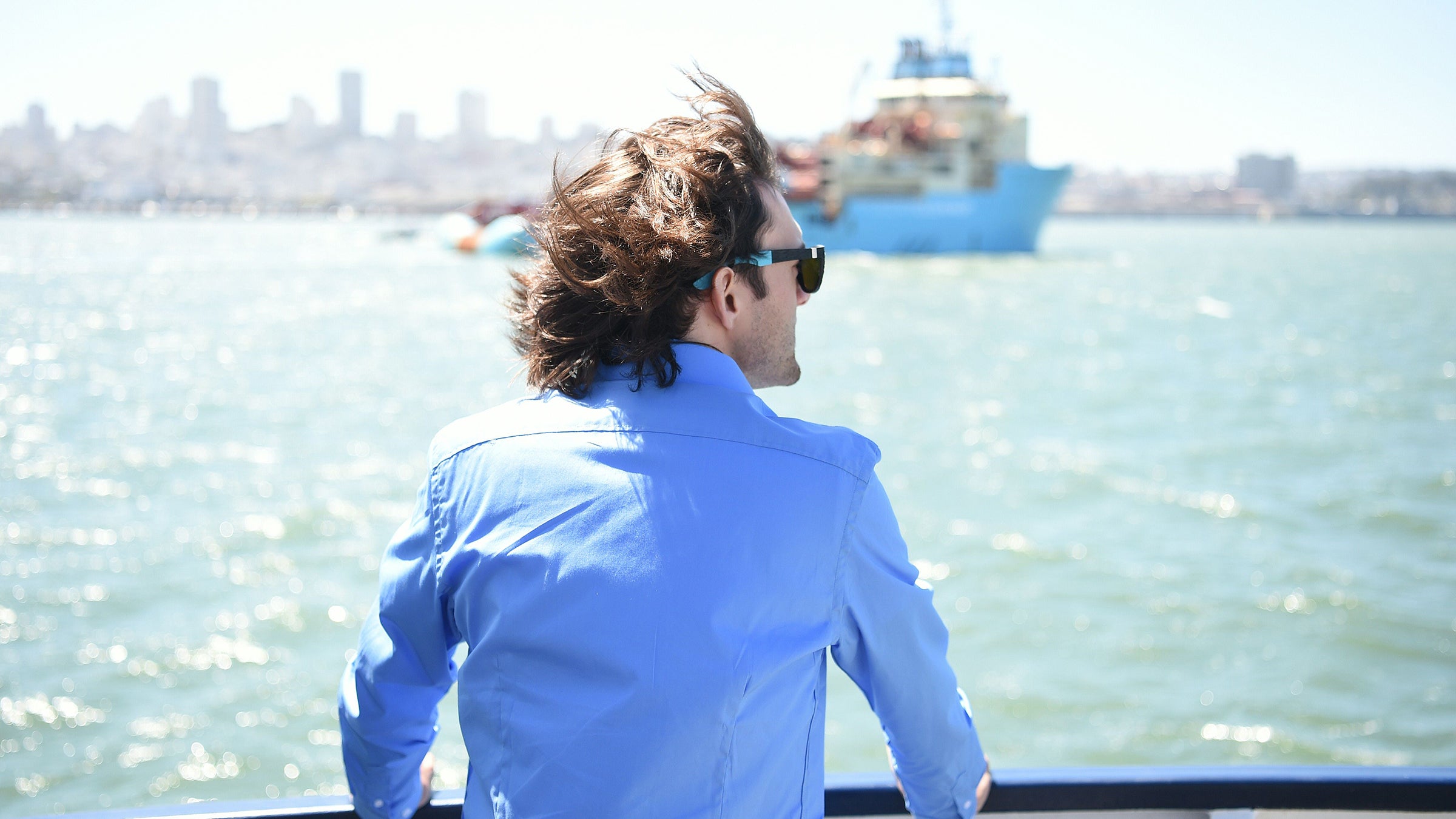 Boyan Slat watches as System 001 is towed out of the San Francisco Bay in September.