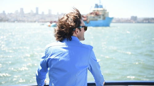 Boyan Slat watches as System 001 is towed out of the San Francisco Bay in September.