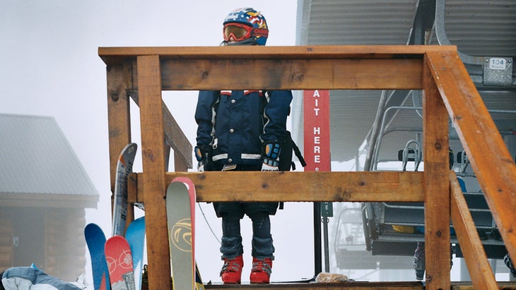 a kid standing on a lift deck