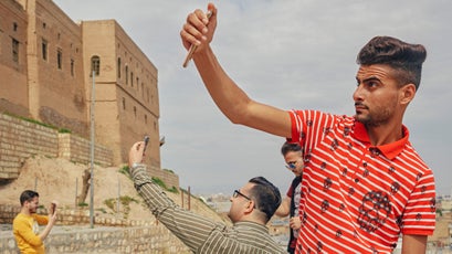 Iraqi men take selfies.