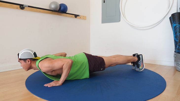 man at bottom classic push-up position in gym