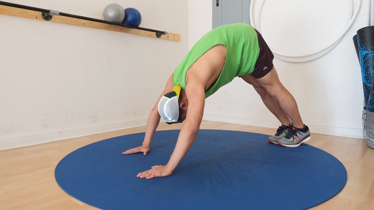 man in downward dog in gym