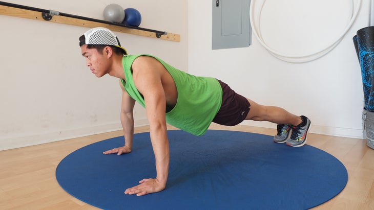 man at top of position with wide arm stance