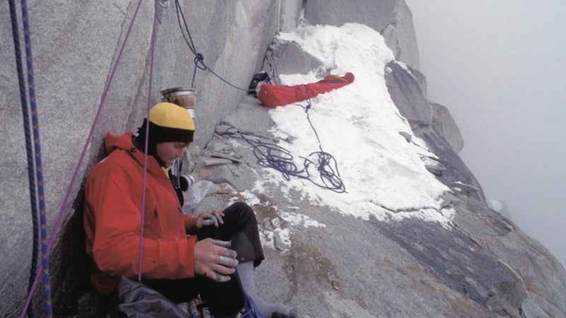 The final bivouac high on Great Trango Tower. The author discovered, shortly after taking this photo, that Lowe was badly injured from his fall and had spent the night sitting on the ledge without getting into his sleeping bag.