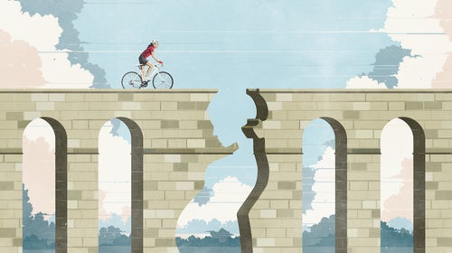 woman riding bike toward cliff