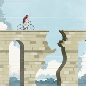 woman riding bike toward cliff