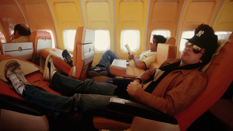 Billy Joel reclines on a flight during a tour