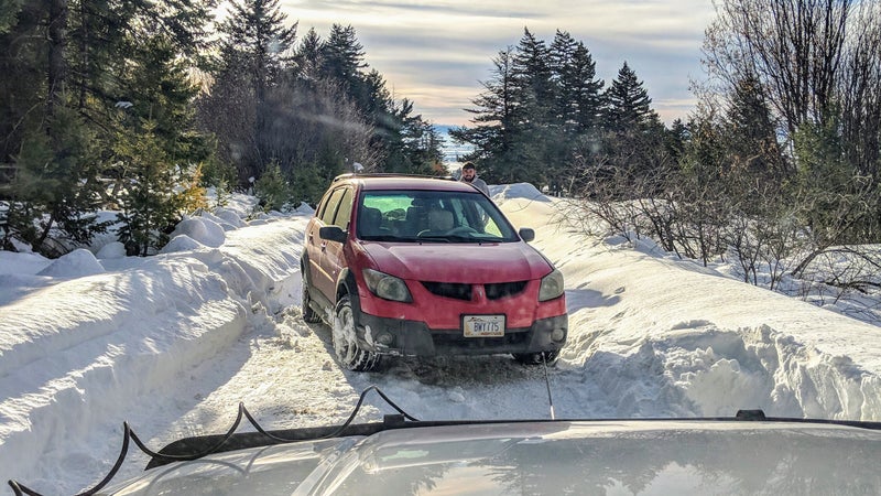 This Pontiac Vibe was equipped with AWD. But because it was wearing crappy tires, and all three of its differentials are completely open, it sent all its power to a single wheel, rendering it completely stranded on this simply snowed-in road. Luckily, I was there with a real 4WD vehicle, wearing winter-compound all-terrains, and had my recovery gear with me, including a winch.
