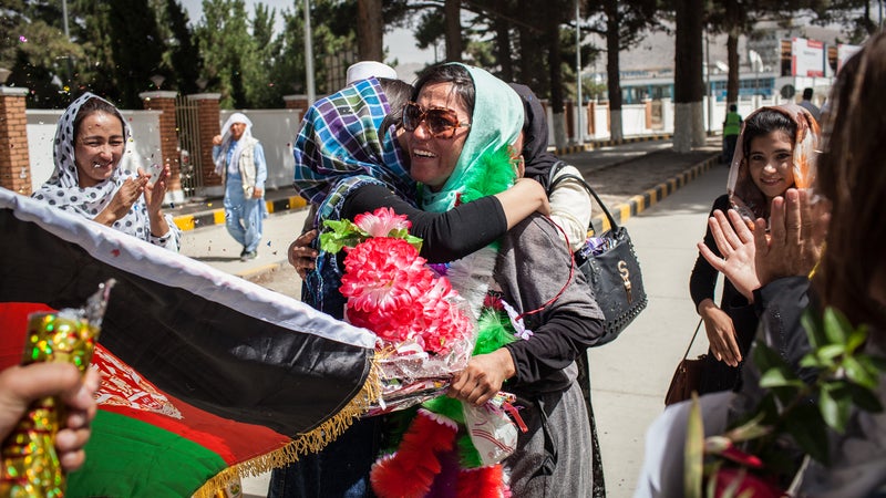 Yousoufi is greeted by family after the climb