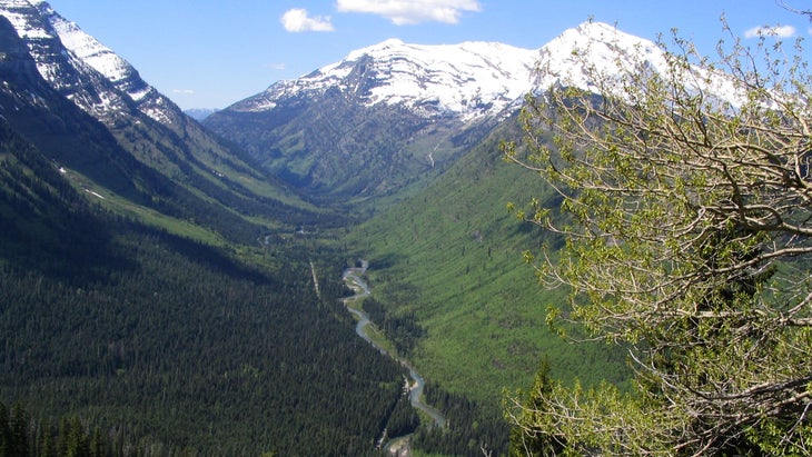 snow-capped mountains with river flowing through the middle