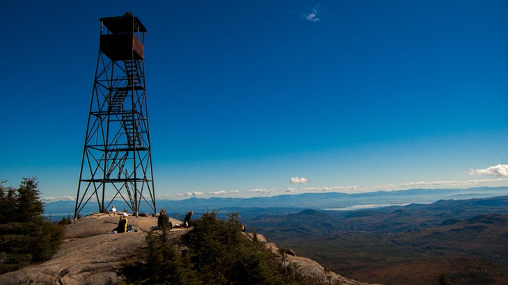 a lookout tower over a cliff and lots of blue sky