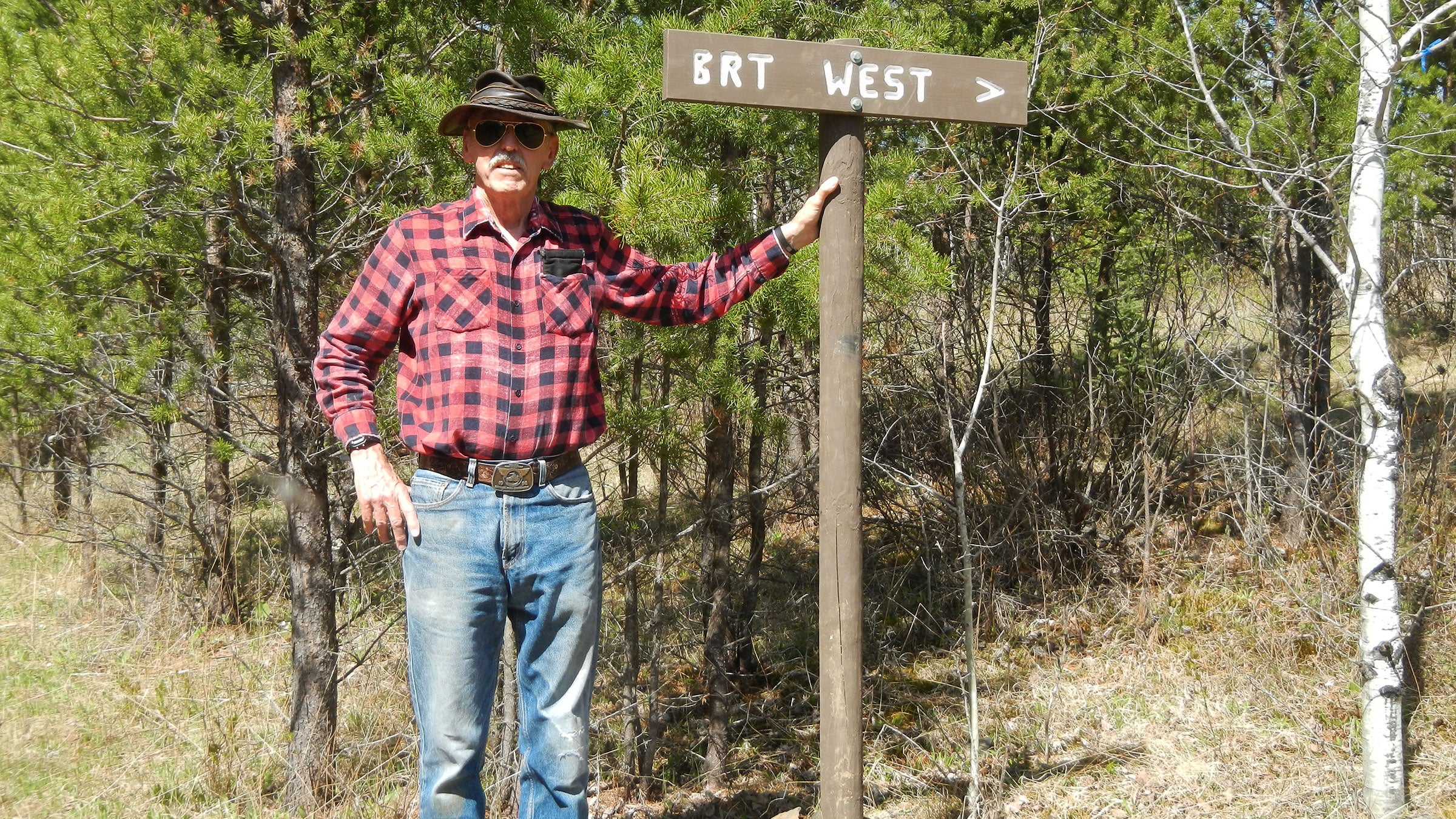 John Elliot near a trail marker for the Border Route Trail he works to maintain.