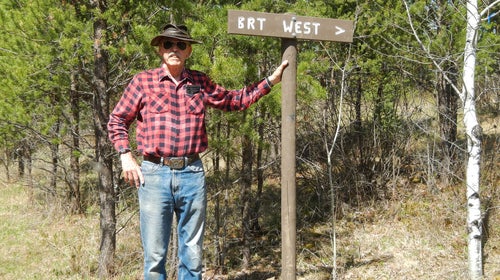 John Elliot near a trail marker for the Border Route Trail he works to maintain.