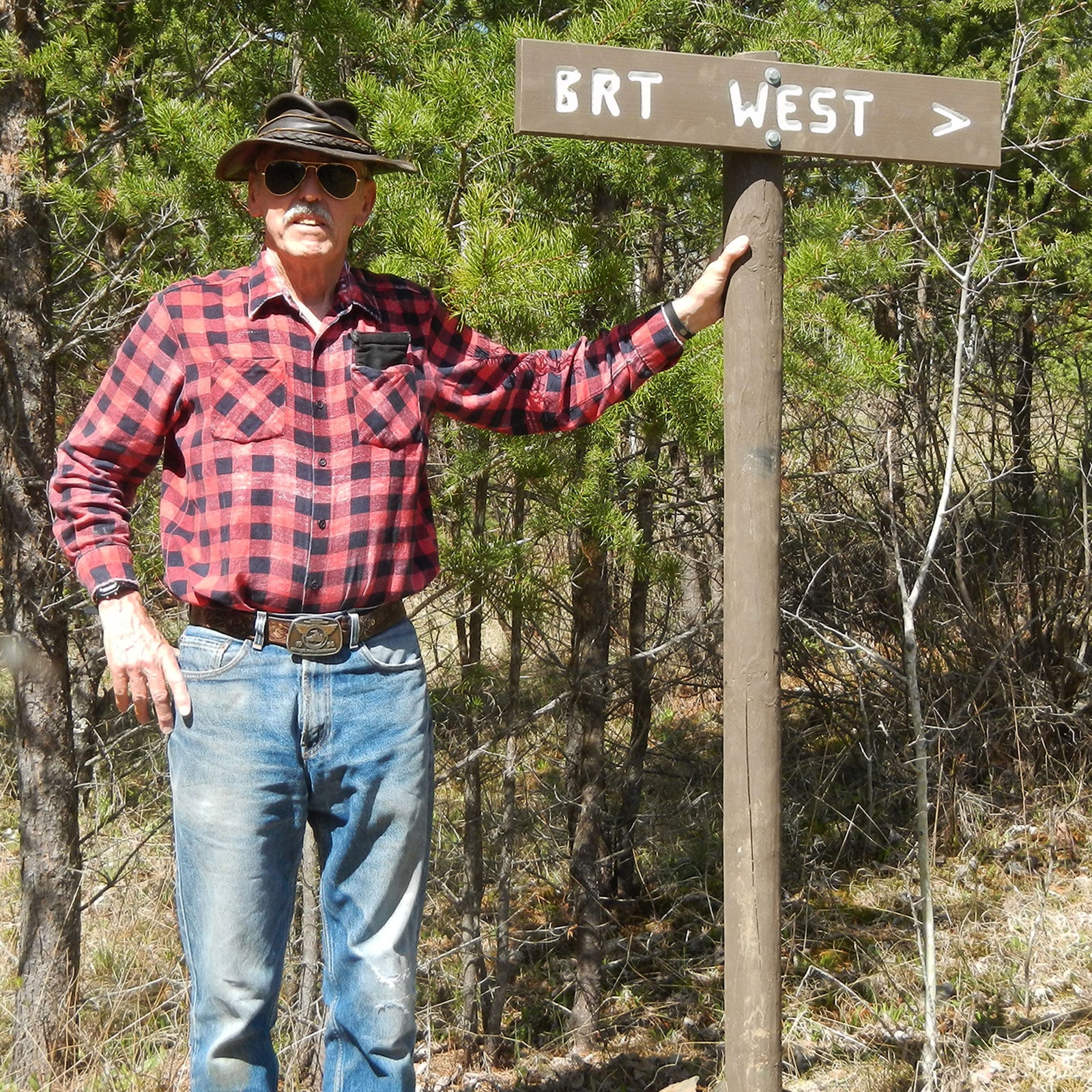 John Elliot near a trail marker for the Border Route Trail he works to maintain.