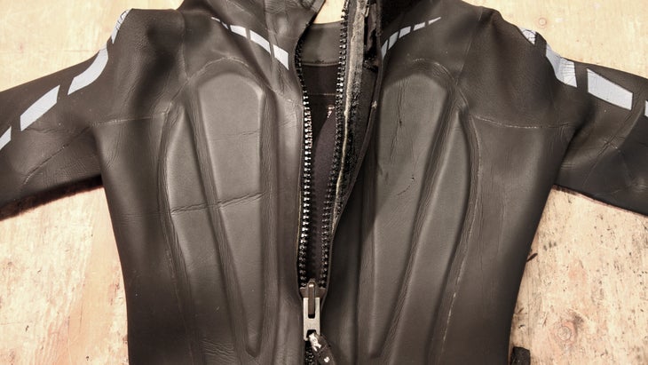 a zipper pictured on a black wetsuit